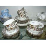 A twenty piece part tea set, white with flower border in pinks, green and gold including cake plate,