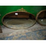 An oval brass framed Mirror.