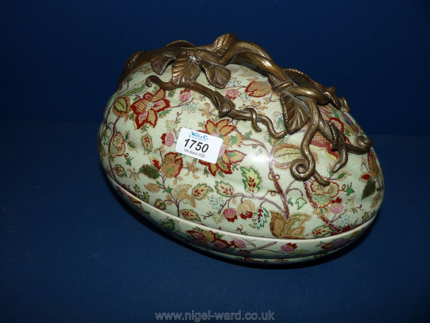 A large ornate hand painted floral egg shaped tureen with metal fret-work to handle.