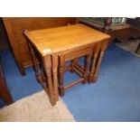 A light Oak nest of three occasional Table standing on turned legs,