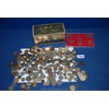 A metal tin of British and foreign Coins and a proof set from 1967.