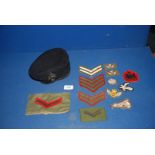 A black Beret with cap badge and a quantity of cloth badges.