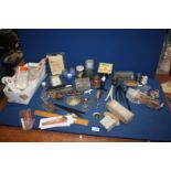 A tray of miscellanea including hip flask, spirit measure, condiment set, brush, glove stretchers,