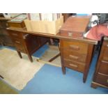 A double pedestal military style Desk with six short drawers and frieze drawer (damaged),