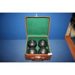 A bowls case having four super grip size 2 Bowling Balls