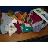 A box of miscellaneous fabric and scarves.