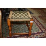 A green and cream woven seated Stool having turned legs and perimeter stretchers,