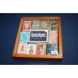 A small display Cabinet with sets of playing cards.