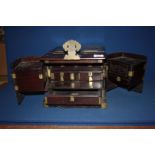 A very heavy Mahogany and other woods travelling Vanity Case having brass fittings including strap