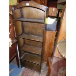 A dark Oak finish floor standing set of Bookshelves having shaped pediment,