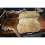 A sheepskin rug together with a deer skin