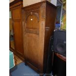 An Oak single Wardrobe, the door having arch and fluted detail,