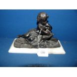 A small cast figure of a child,