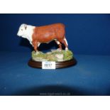 A Country Artists model of a horned Hereford Bull on a plinth; no: 01120,