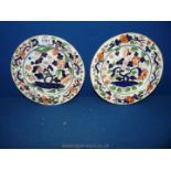 Two hand painted oriental plates white with blue and orange and gold embellishment.