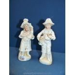 Two porcelain figurines of a girl and a boy.