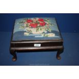 A low cabriole legged dark Mahogany framed Footstool having drop-in upholstered top decorated with