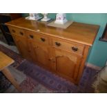 A craftsman made contemporary mid-Oak Sideboard having three frieze drawers and three shaped raised