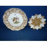 Two wall plates in white and gold one having embossed edge and two birds in the centre,