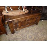 A reproduction Oak Blanket Box having five panels to the front, three having arch detail,