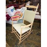 A woven beige strapwork lightwood framed armed Rocking Chair reminiscent of Scandinavian design