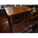 A nest of three Oak occasional Tables standing on turned legs,