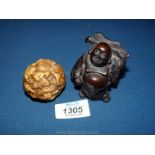 A circular Netsuke and a Buddha.