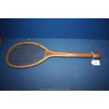 A Victorian tennis racquet with wooden handled shaft,