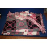 A double pink/black Welsh blanket bed throw.