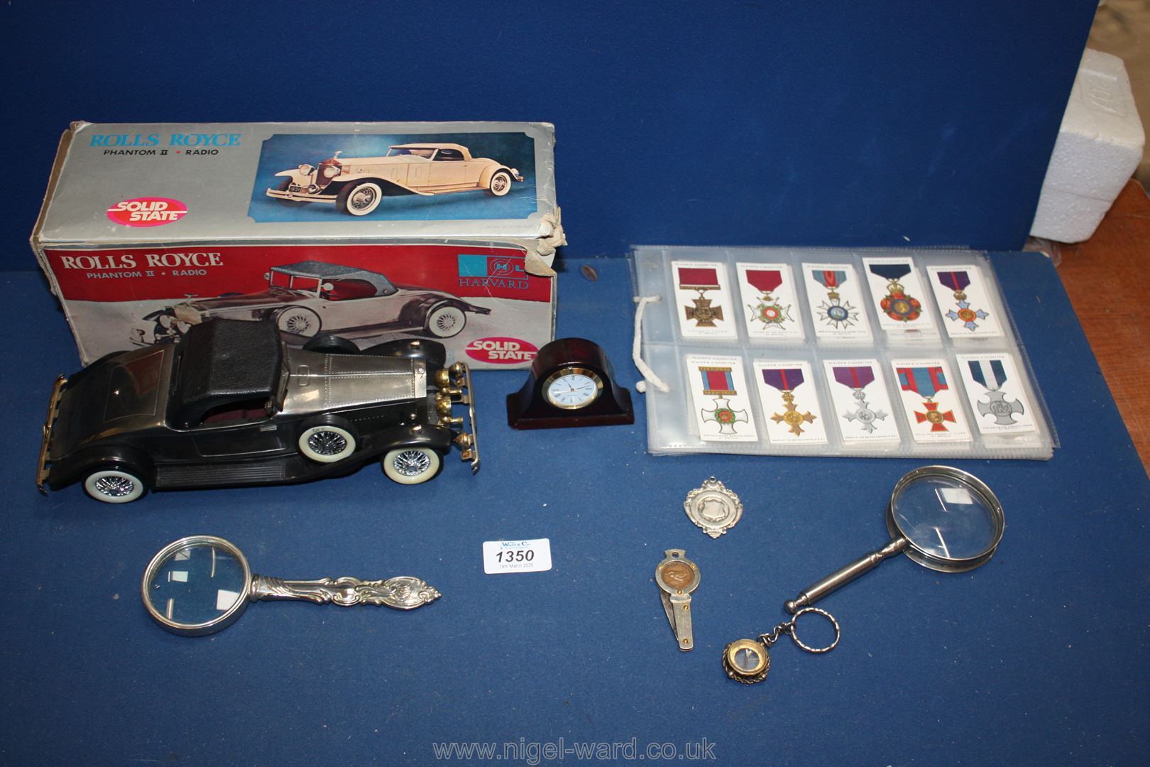 A Rolls Royce Phantom II radio in box with two metal magnifying glasses, a small clock,