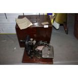 An attractive wooden cased silent sewing machine made by Willcox and Gibbs, New York, London,