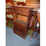 An unusual Oak floor standing Cupboard having raised and fielded door to the base,