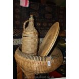 A large bottle in basket plus a snake charmer's Basket.