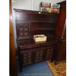 A darkwood Sideboard having three carved detailed doors to the base,