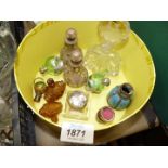 A yellow box of perfume bottles including green, blue metal vase, clear with metal decoration etc.