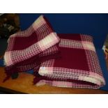Two Derw Welsh wool honeycomb Blankets in dark red, pink and cream.