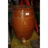 An stoneware ''Etherium Spring Water'' Barrel dispenser with tap