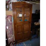 An Oak Corner Cabinet over Cupboard,