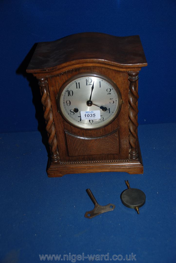 A Mantle Clock with twisted columns, with key.