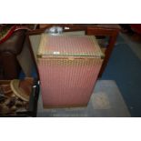 A pink, gold shaded, glass topped Laundry Basket of Lloyd Loom style,