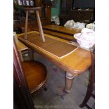 A heavy Oak wind-out Dining Table standing on turned legs,