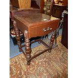 An unusual darkwood Side Table standing on square section type turned legs with perimeter