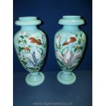 Two large turquiose vases embossed with large lillies and flowers. 16 3/4" tall (approx).
