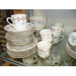 A pretty china Teaset, white with pink and gold decoration with blue leaf consisting of eight cups,