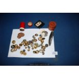 A box of mixed army Buttons, corkscrew, leather box, red container of one pennies, etc.