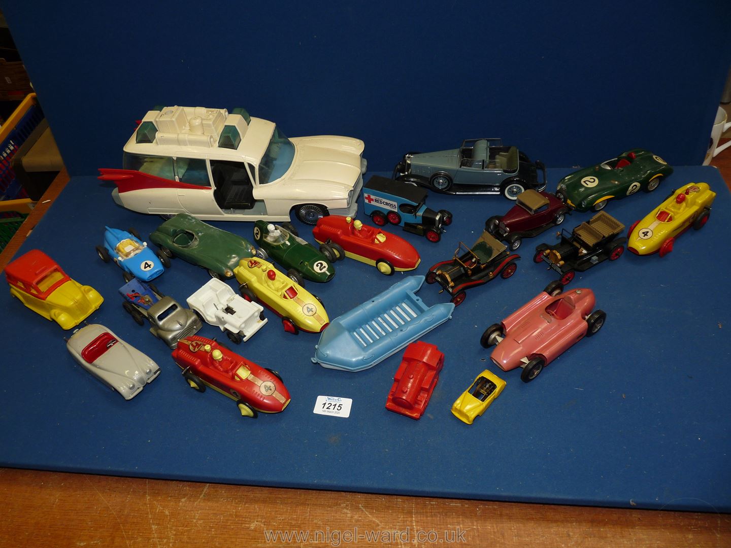 A large box of plastic racing cars and vehicles.