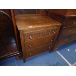 An Old Charm/Priory Oak style Chest of three long drawers, the top drawer with fluted front,