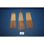 Three good Congolese hair combs, probably Teke peoples, each with a woven/rattan handle,