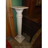 A cream painted pedestal having a fluted pillar, the top 10 3/4'' x 10 5/8'' x 43'' high approx.