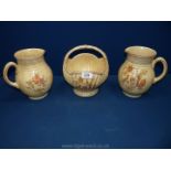 An Arthur Wood china basket and two matching jugs in cream mottle and pheasant design.